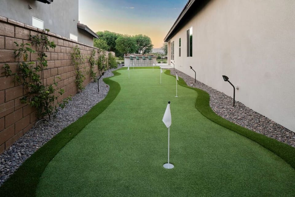 Private putting green along the side yard for laid-back afternoon fun