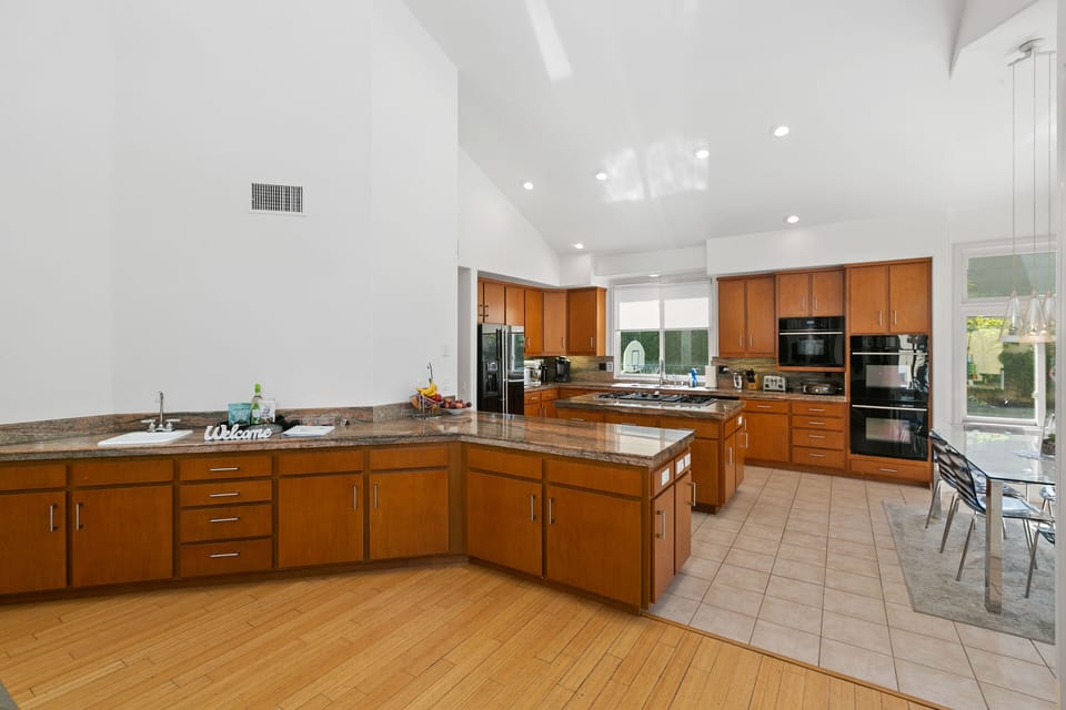 Open Concept Kitchen with Island, Bar Sink, Dining Tabe, Overlooking Pool & BBQ