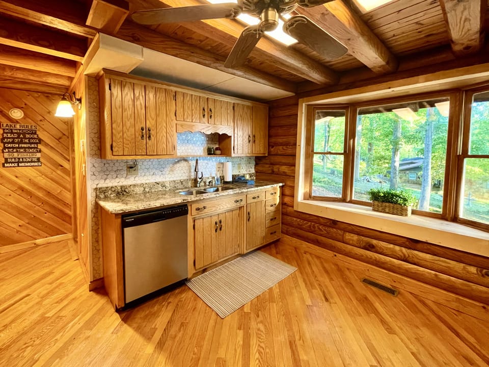 Additional view of kitchen with large bay window, looking out to the side yard.