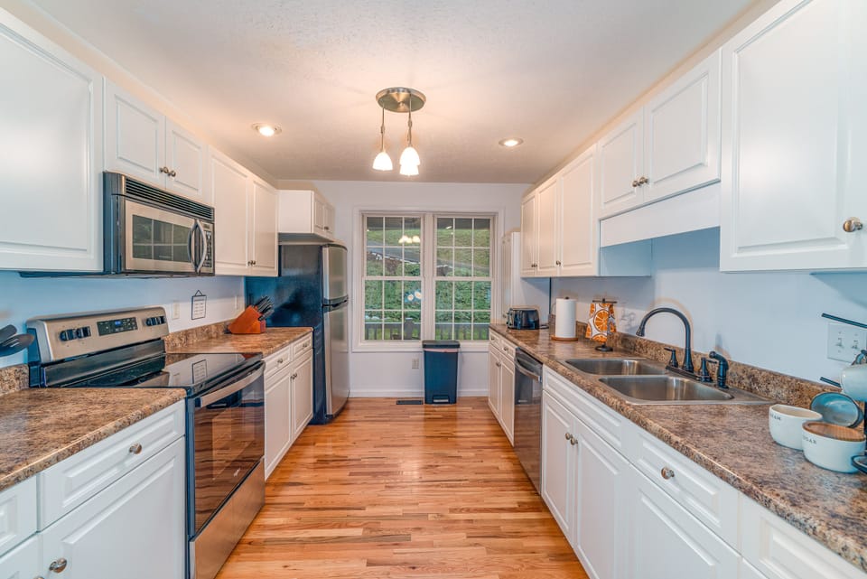 Fully stocked kitchen; cookware, cutlery, silverware, plates/bowls, dish towels