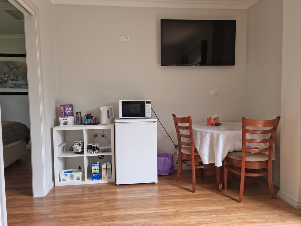Two Seat dining table, mini bar fridge and tea, coffee kettle. HD TV