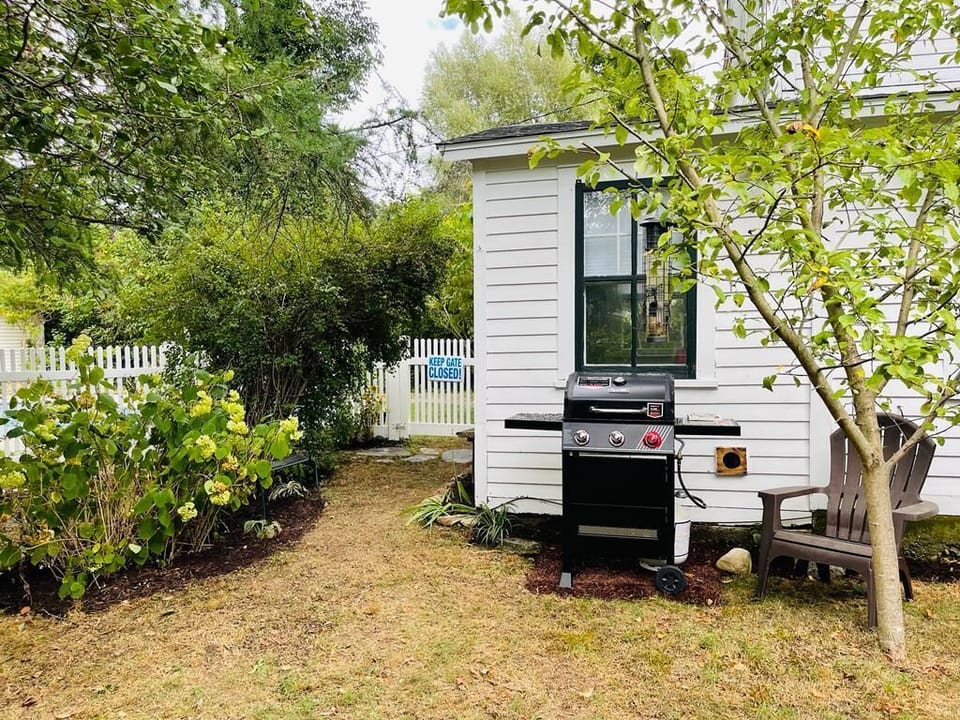 Small yard with gas grill off of the back sunroom