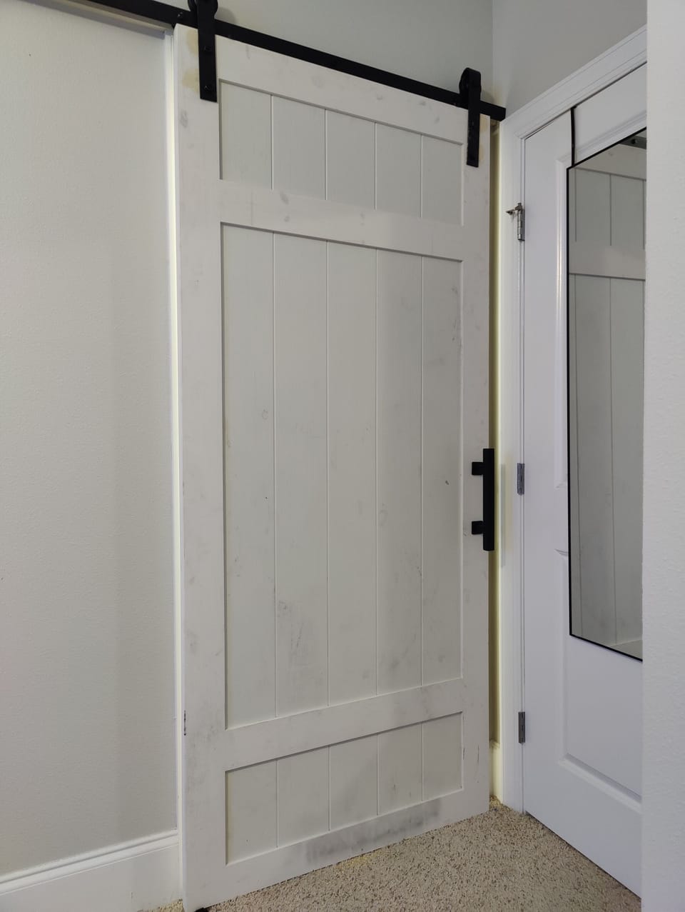 Barndoor access from secondary bedroom to bathroom
