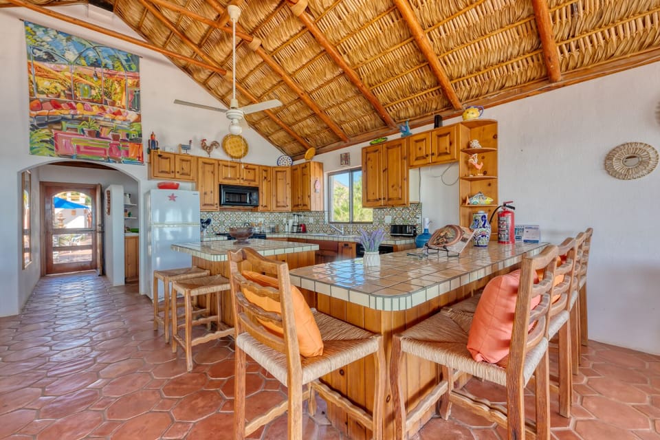 The kitchen island and bar area have plenty of seating to enjoy breakfast and coffee together in the morning.