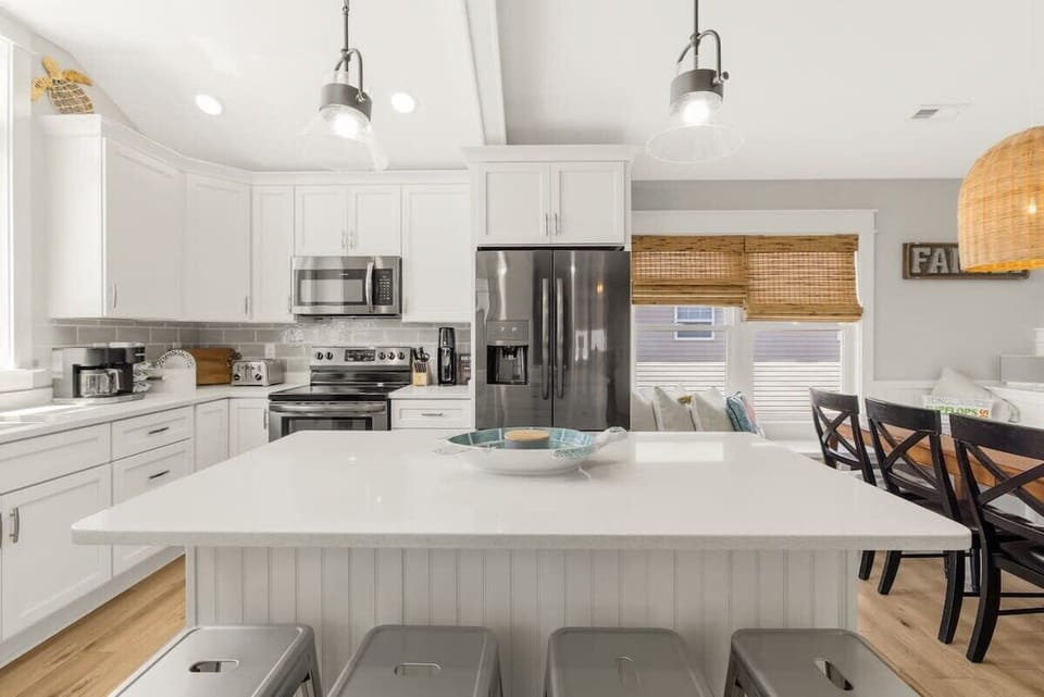 Gorgeous, updated kitchen with quartz countertops, stainless steel appliances, and a large kitchen island - perfect for cooking, gathering, and entertaining during your stay.