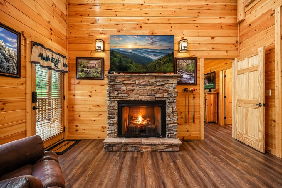 Cozy living room featuring a 55" TV and a warm gas fireplace—perfect for movie nights after a day in the mountains.