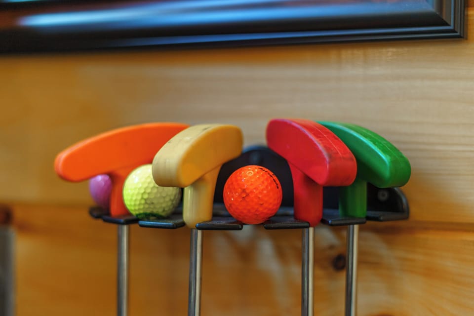 Putters and golf balls included for your own 5‑hole mini‑golf course, perfect for friendly family competitions