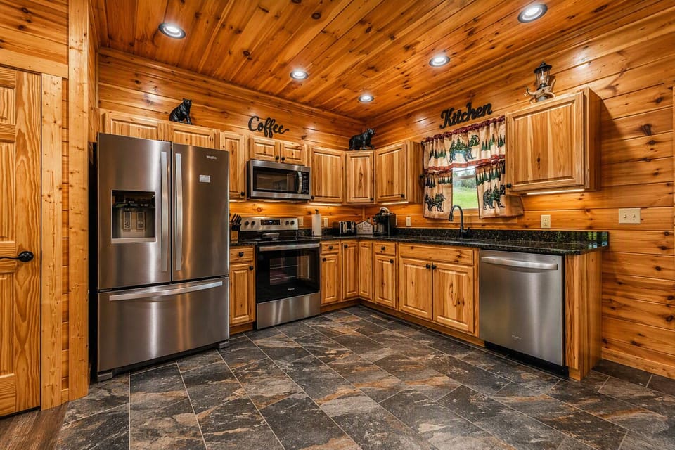 Stylish French‑door refrigerator complemented by rustic bear décor, bringing a warm mountain touch to the kitchen