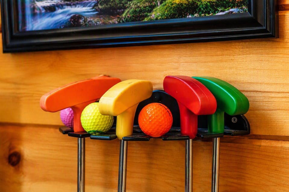 Putters and golf balls included for your own 5‑hole mini‑golf course, perfect for friendly family competitions