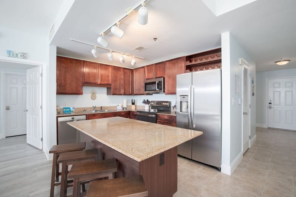 Fully Stocked Kitchen with Ocean Views, Island Bar Seating, Stainless Steel Appliances and Dual Coffee Machine