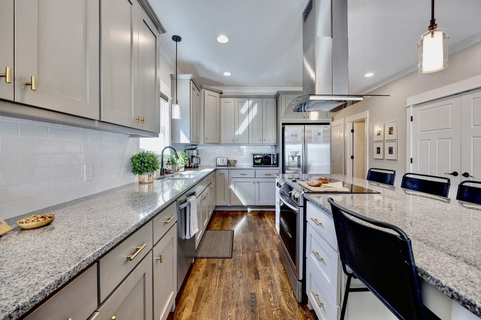 The kitchen boasts stainless steel appliances and quartz countertops.