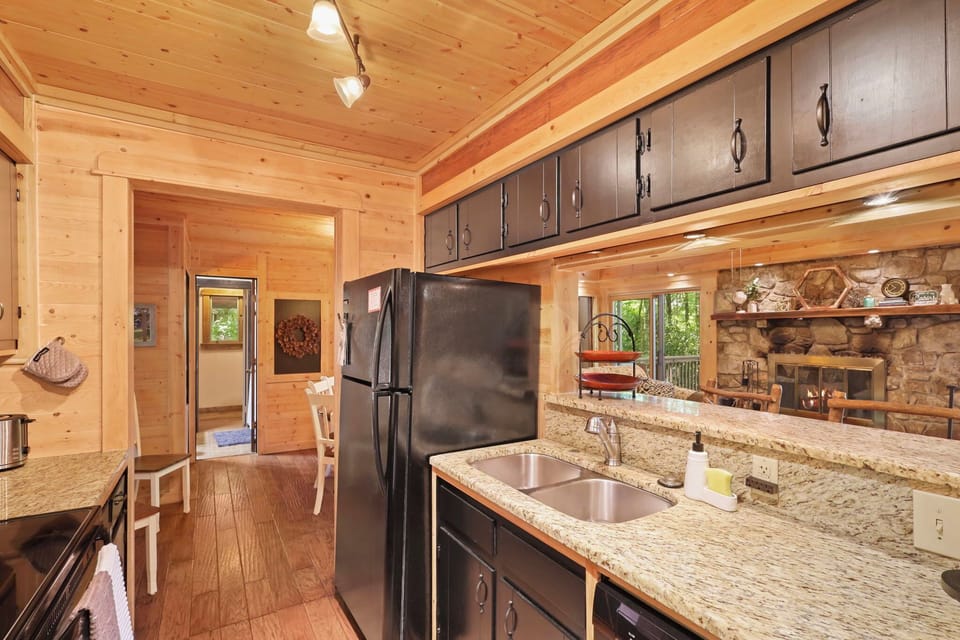 Fully stocked kitchen with fridge/freezer, oven, and dishwasher.