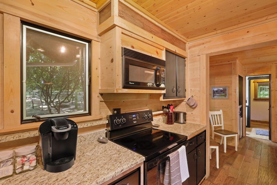 Keurig and drip coffee pot provided, along with sugar and creamer.