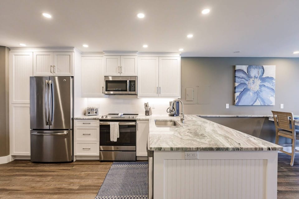The kitchen features full-size stainless appliances, ample storage and plenty of meal prep area.