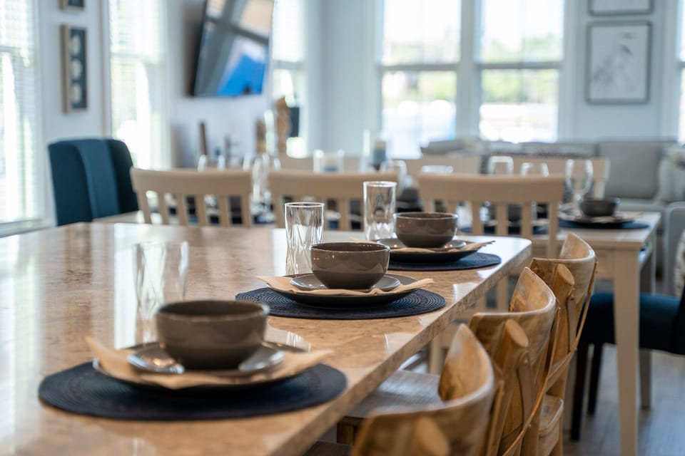 Gather around this beautifully set dining table where memorable meals and conversations await your group.