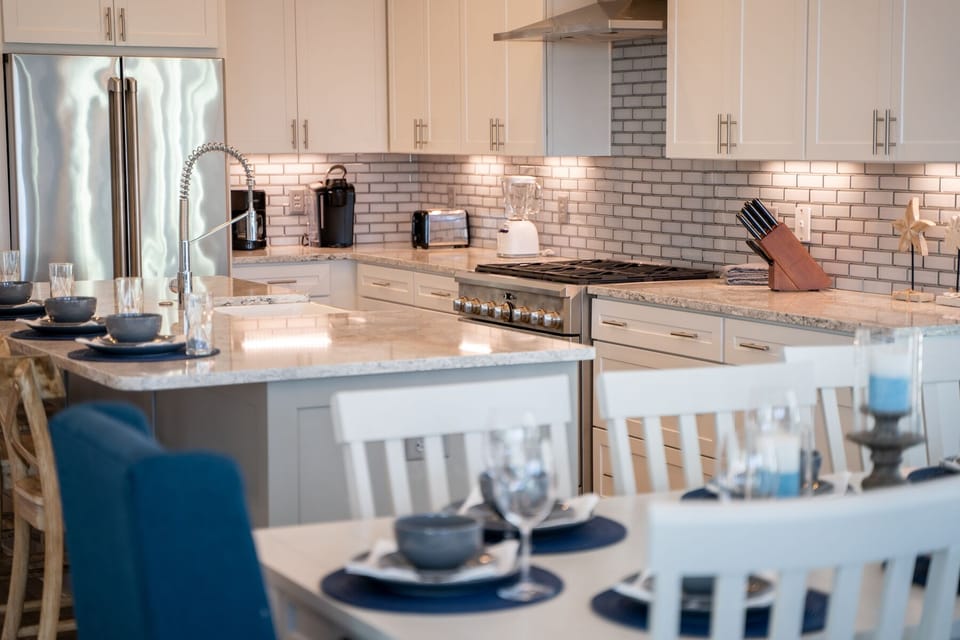 Your gourmet kitchen awaits with granite counters, premium appliances, and elegant subway tile—perfect for morning coffee or cooking together.