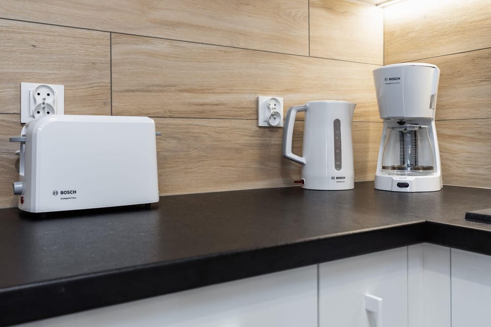 A kitchen counter with small appliances, including a toaster and a coffee maker.