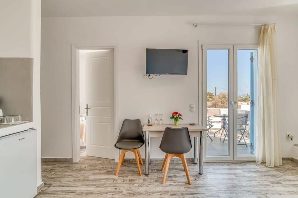 Open Plan Kitchenette and Dining Area
Fully equipped cooking and dining corner with sleek white cabinetry