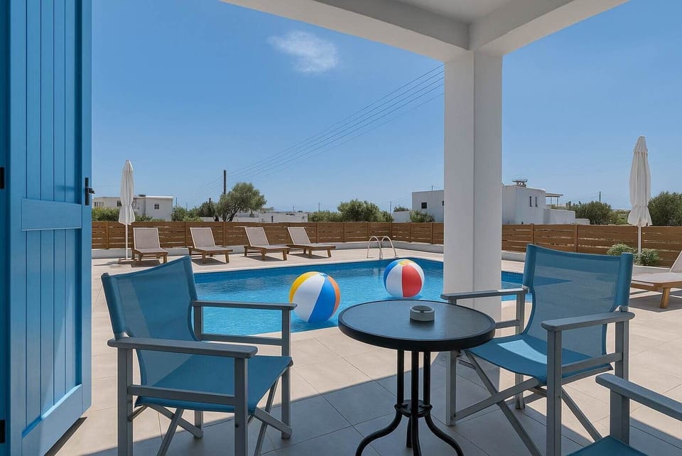 Covered Patio Area by the Pool
Outdoor shaded seating next to the pool, ideal for meals or drinks.