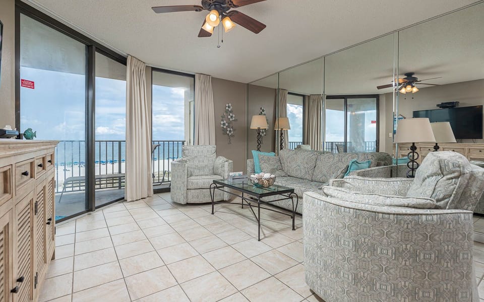 Unwind in the spacious living area featuring a queen sofa sleeper and beachfront view, perfect for relaxation