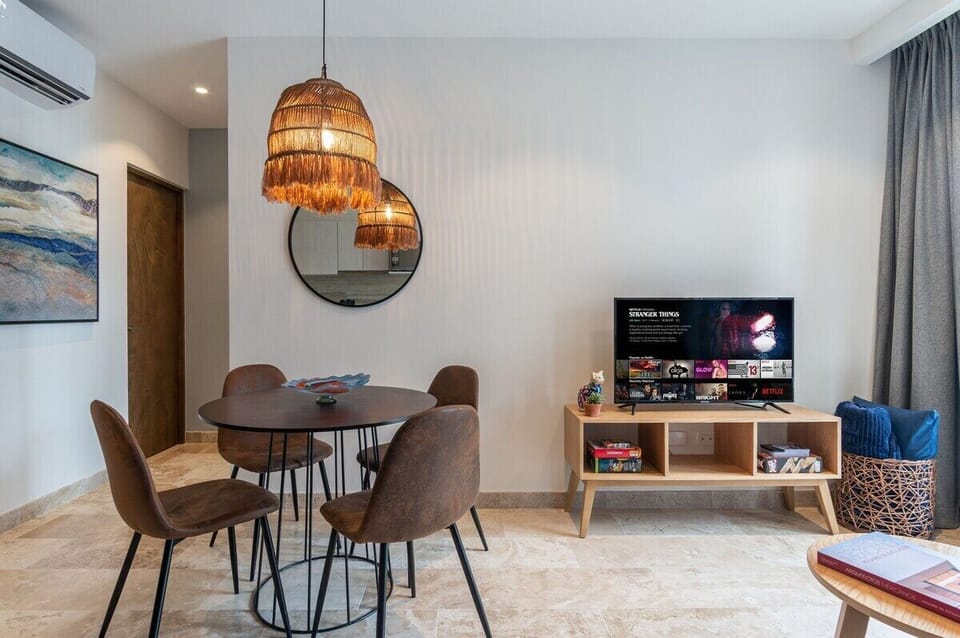 “Relax in the sunlit living room featuring a premium sleeper sofa and custom-designed furnishings. The open layout flows into a fully equipped kitchen with sleek granite countertops, perfect for preparing gourmet meals. Unwind with your favorite show
