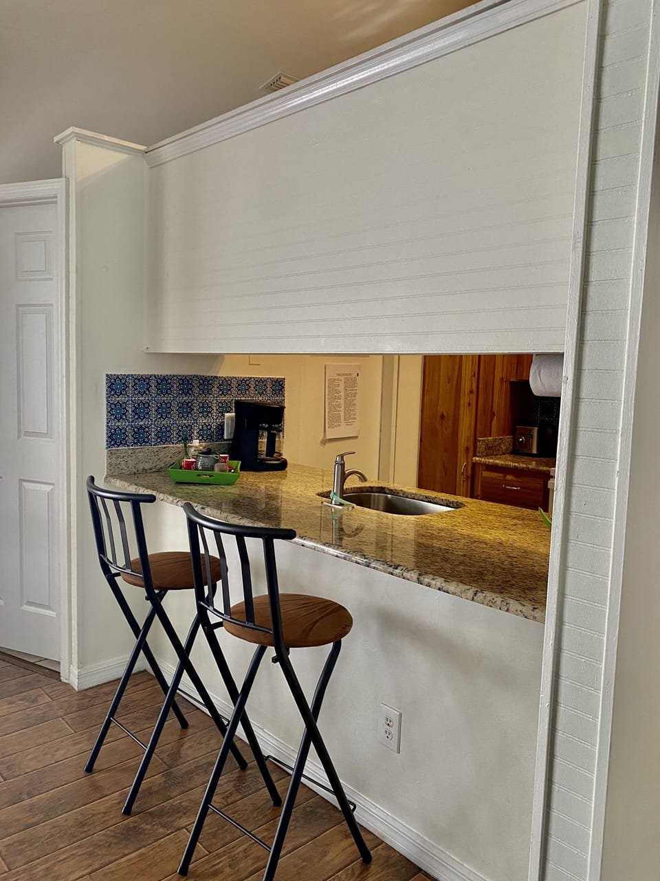 Bar stools in this granite kitchenette.