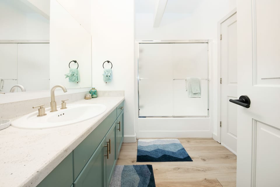 Full shower and tub combo for this bathroom. Towels, soap, shampoo & conditioner