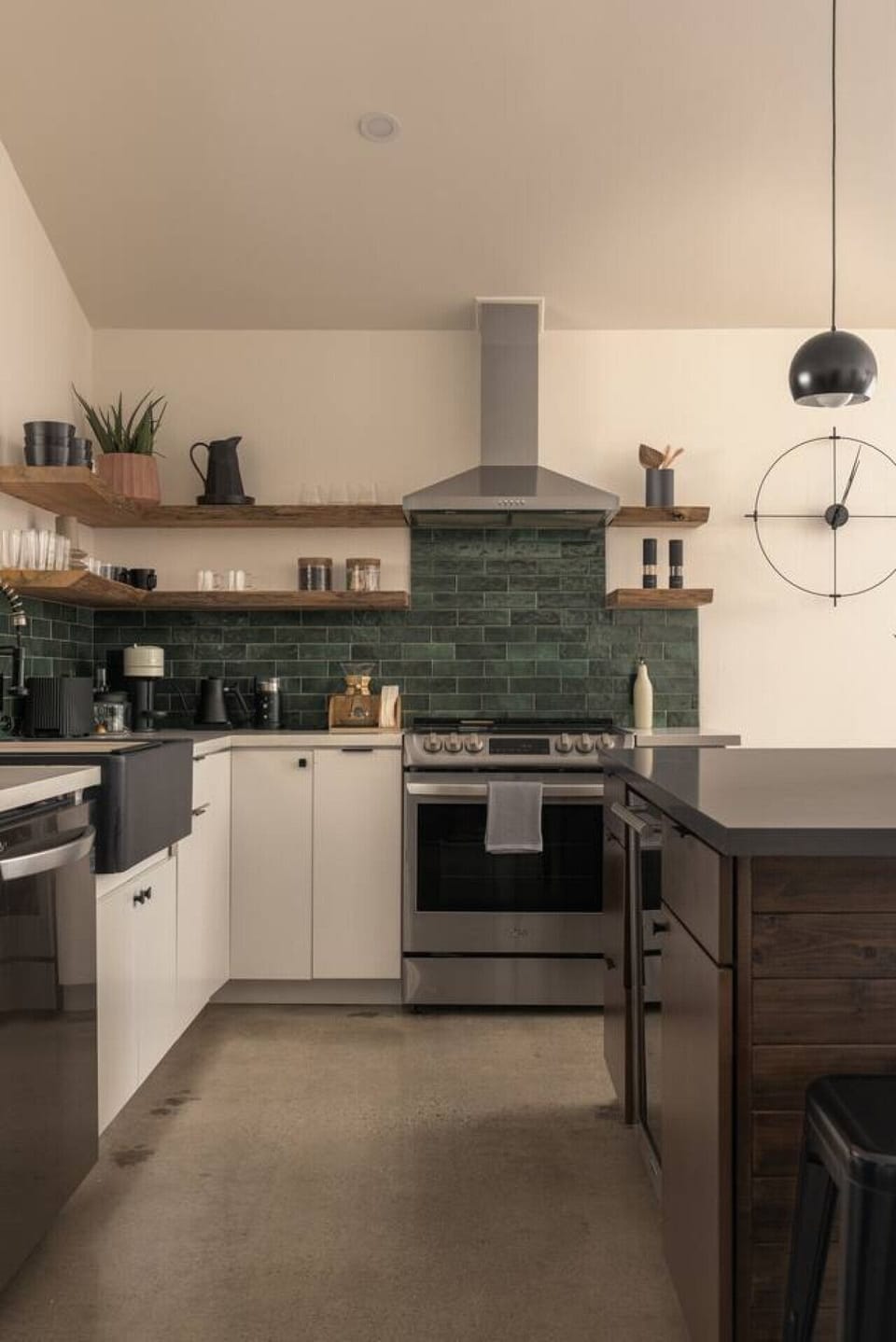 Designer KitchenThis fully stocked kitchen features open shelving, rich green tile, and modern appliances, blending form and function for everything from morning coffee to gourmet dinners.