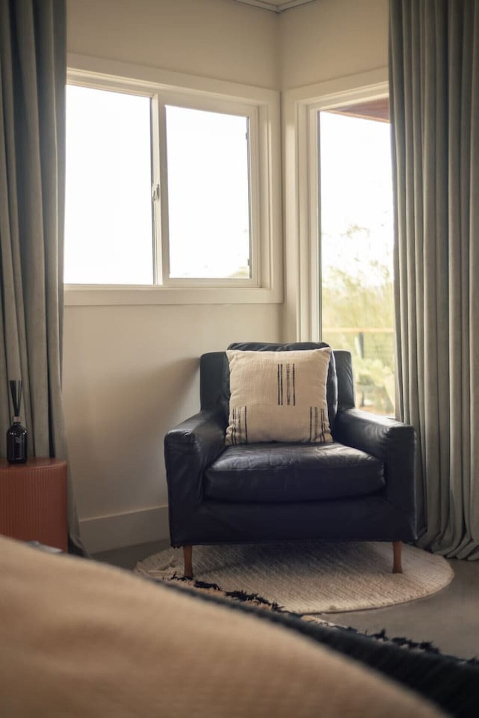 Reading Corner with a ViewA comfy armchair nestled by the windows offers a quiet spot to read, relax, or sip coffee while soaking in desert scenery.
