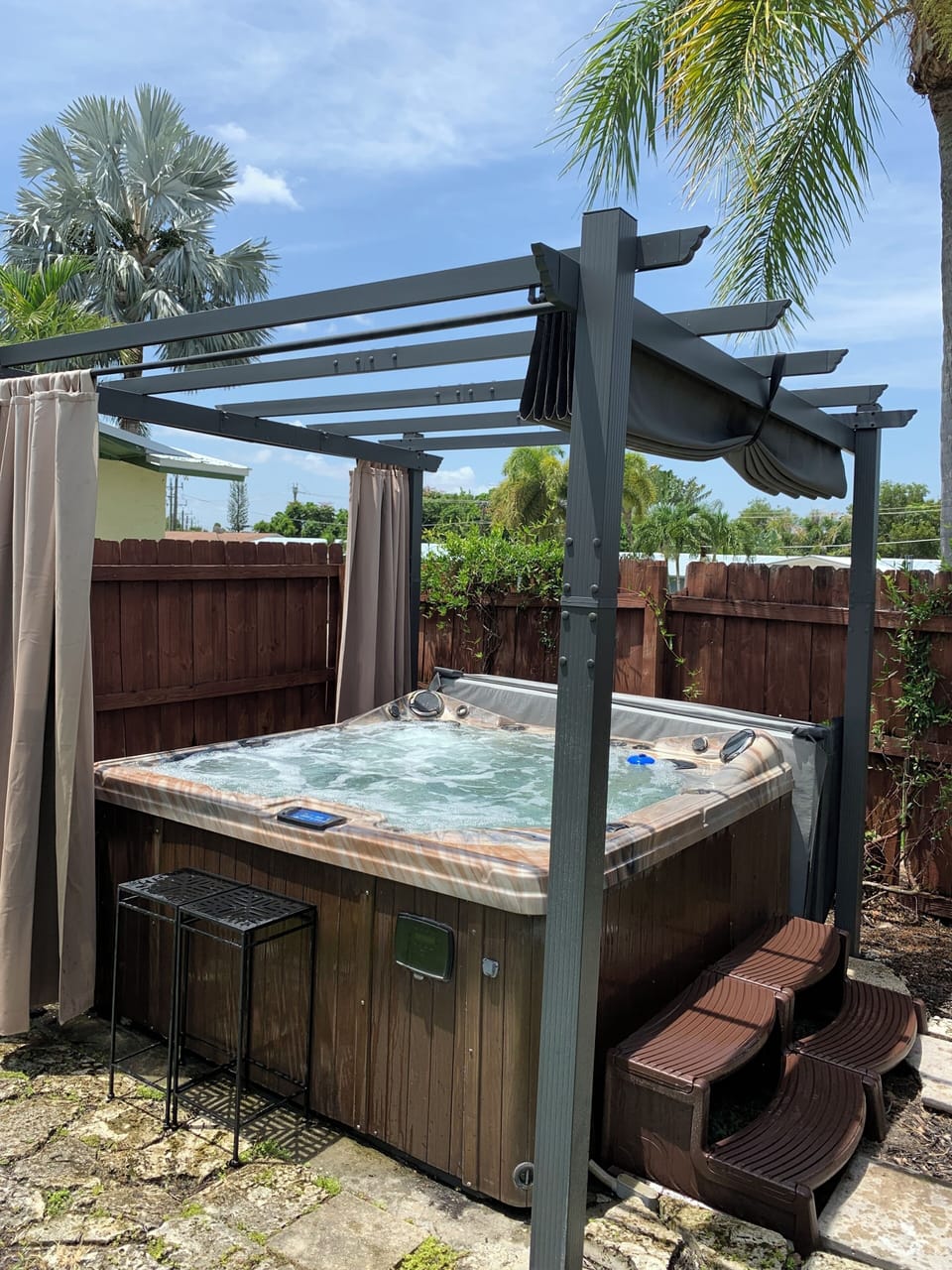 Out door hot tub, with retractable roof and privacy curtains.