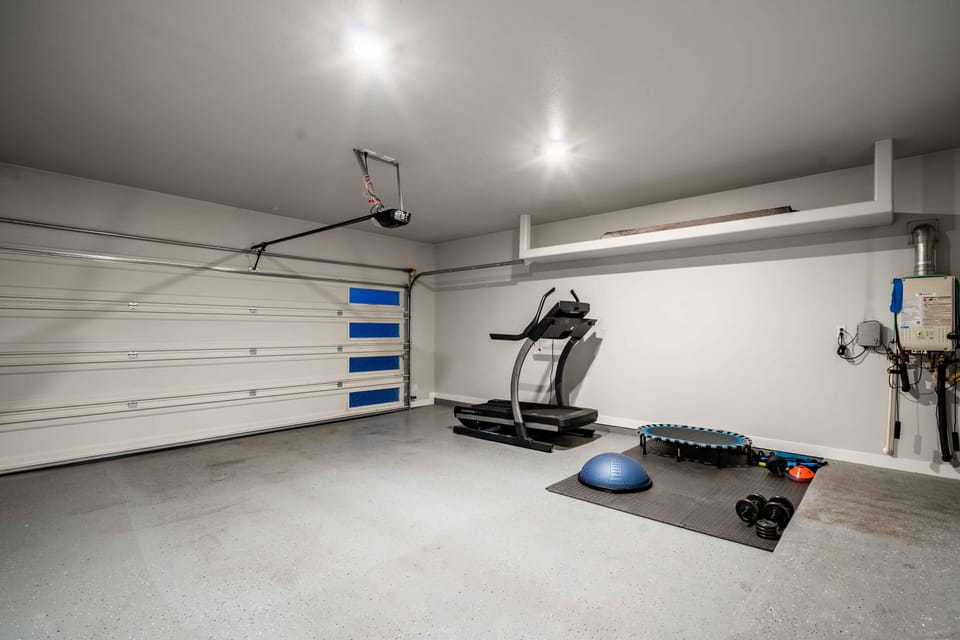 Workout area with treadmill and some equipment