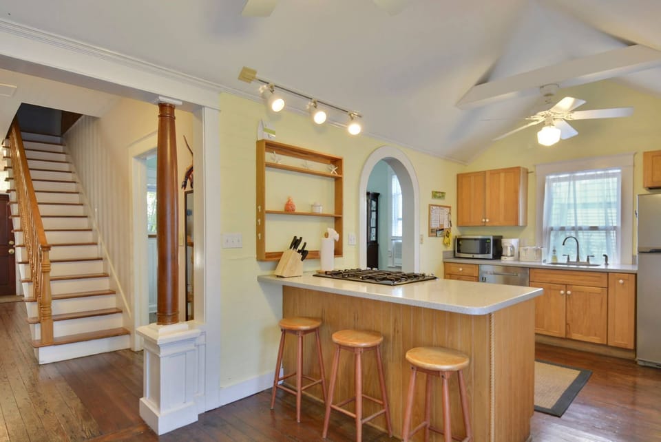Spacious kitchen features a countertop breakfast bar.