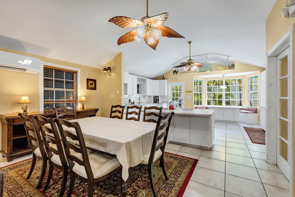 Bright dining area with warm finishes, a spacious kitchen, and a cozy breakfast nook overlooking the yard.