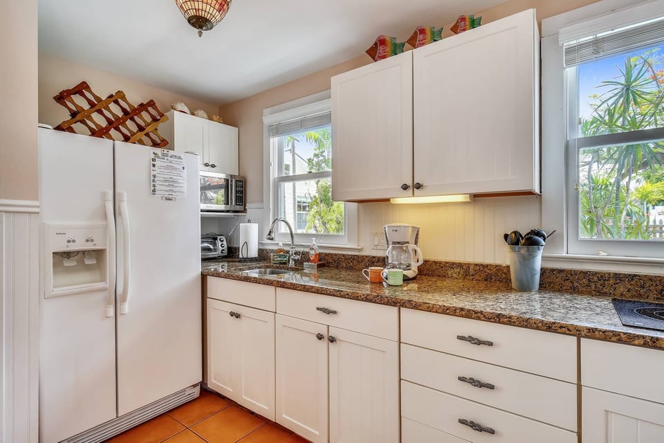 Bright kitchen features modern appliances.