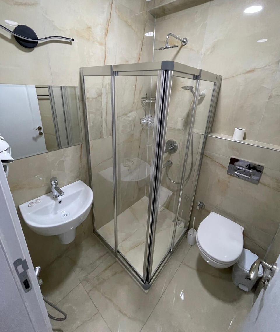 Family Triple Room | Bathroom | Rainfall showerhead, hair dryer, slippers, towels