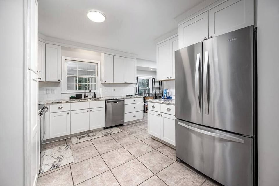 Stocked kitchen with coffee maker, tea, and cooking supplies (pots, pans, utensils, blender, etc.)