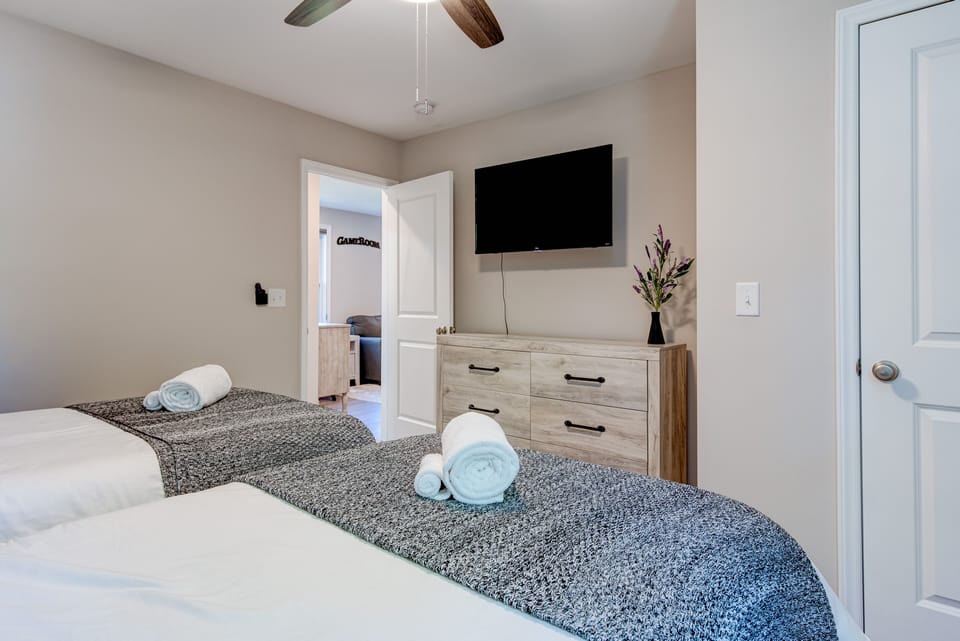 Second floor twin room with smart TV and walk in closet.