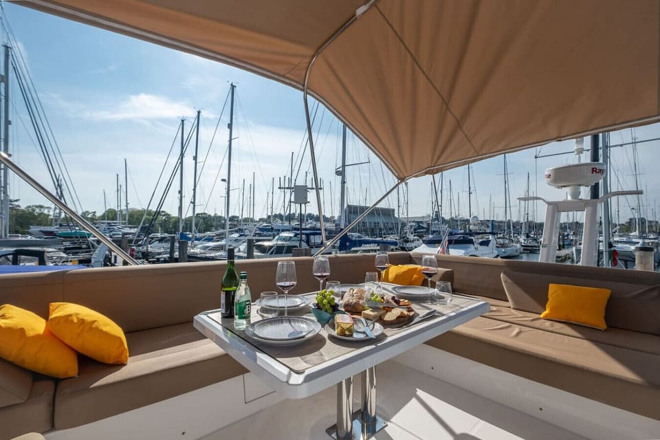 Wine and cheese on the shaded aft deck with the marina stretching out ahead.