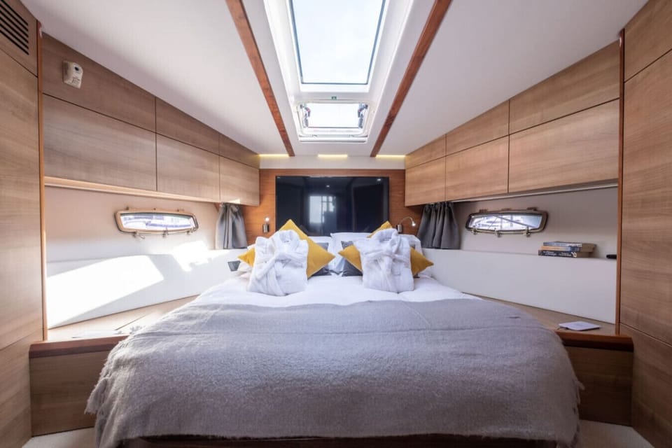 The master cabin with skylight, en suite shower and plush robes waiting.