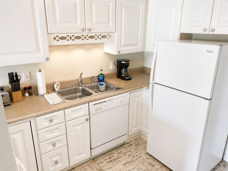 Kitchen with fridge, washer, and oven/stovetop.