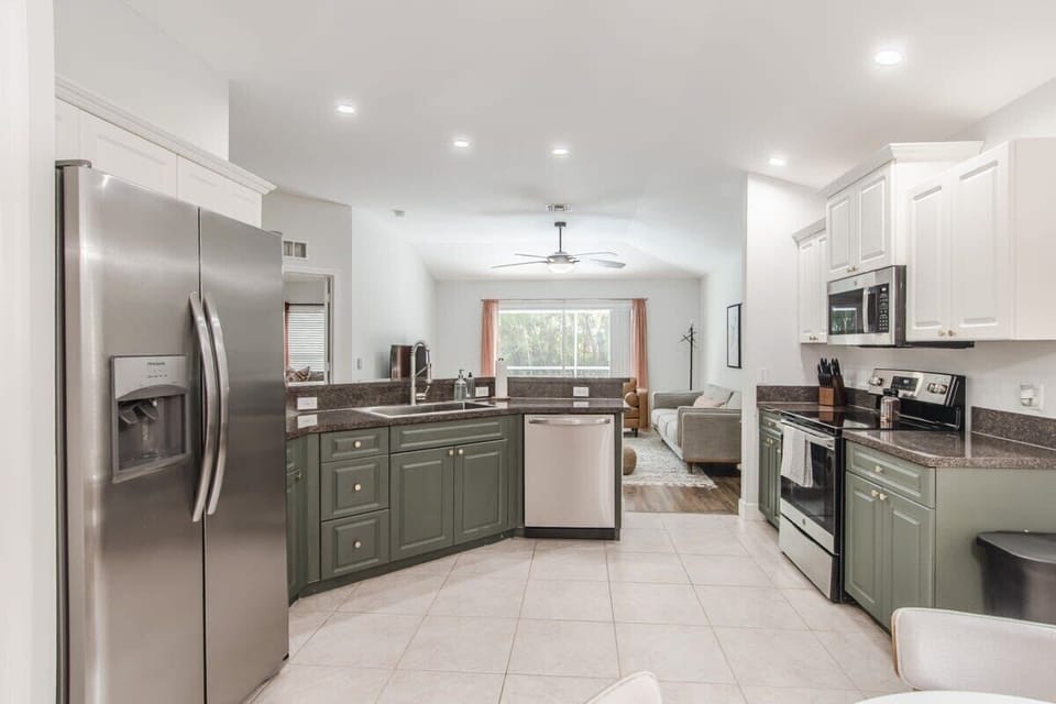 Kitchen opens to the living room and equipped with basic utensils and cookware.
