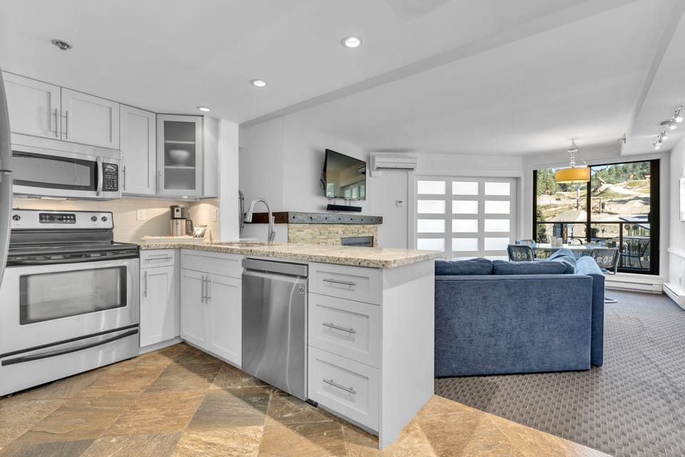 Open concept with the second bedroom doors closed for privacy. Table for 4!