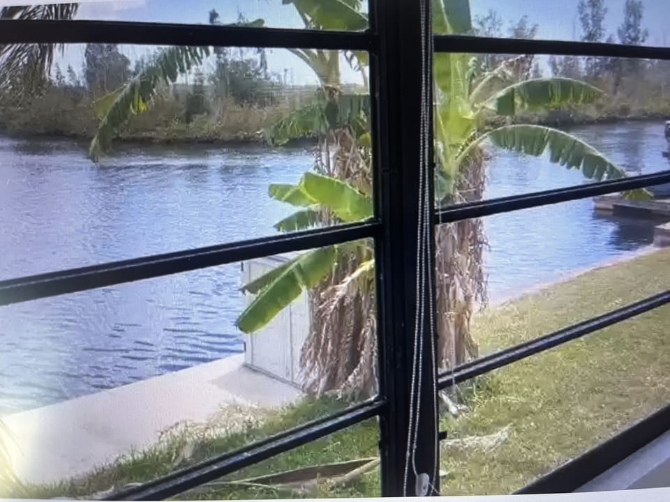 Sunroom has beautiful views and access to covered patio. 