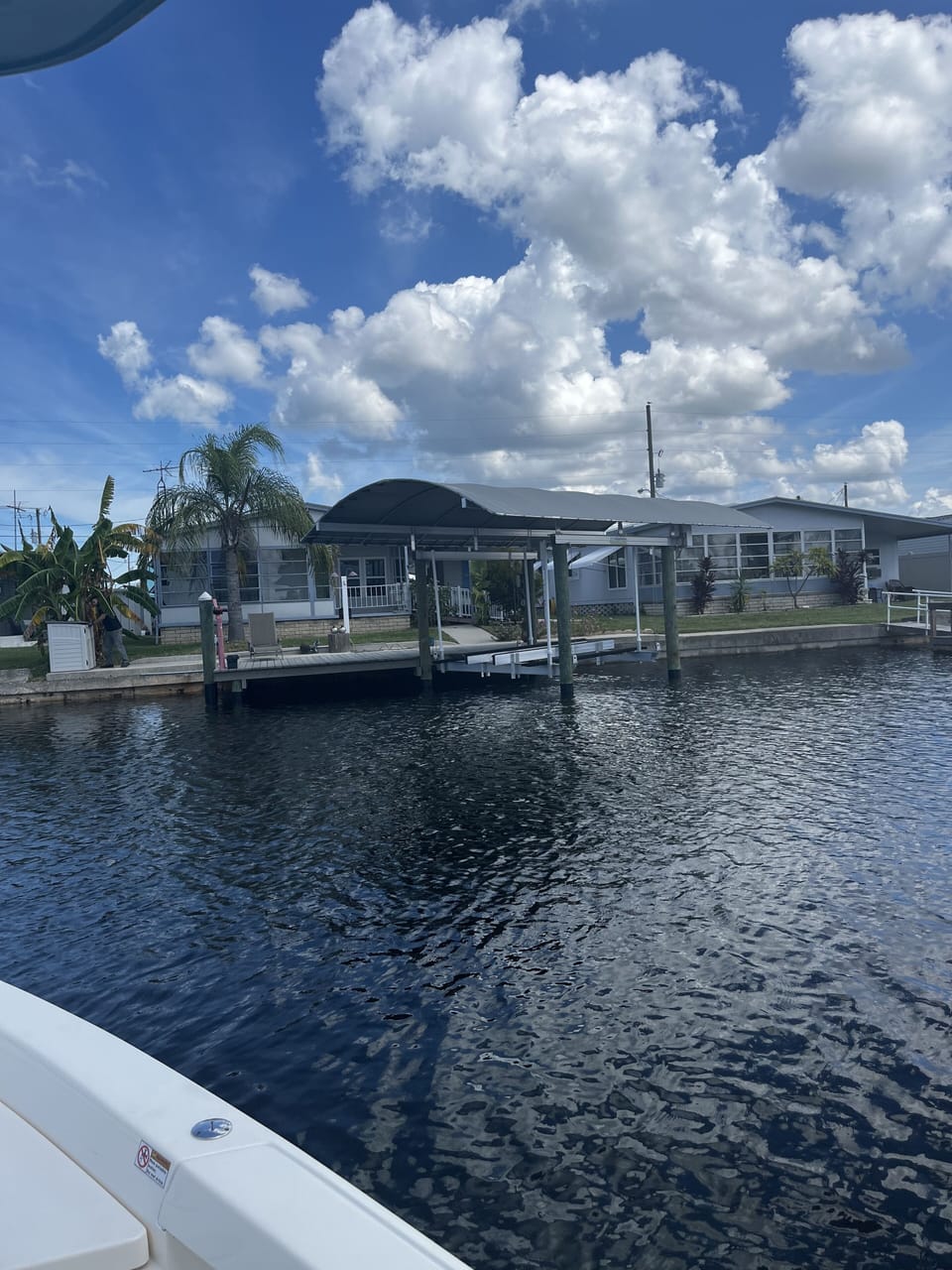 View of home and boat lift from the water. Room on the deck for fishing