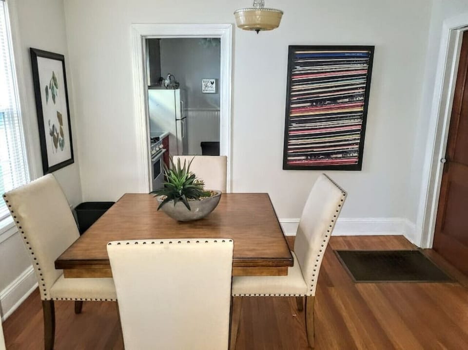 Adjacent to the kitchen and living room, this elegant dining space seats four comfortably and is flooded with natural light, making it perfect for meals or a cozy gathering spot.