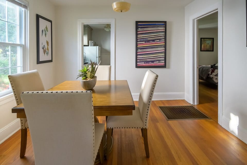 Adjacent to the kitchen and living room, this elegant dining space seats four comfortably and is flooded with natural light, making it perfect for meals or a cozy gathering spot.