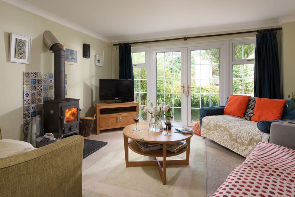 The living room, wood burner and TV - Pump Cottage