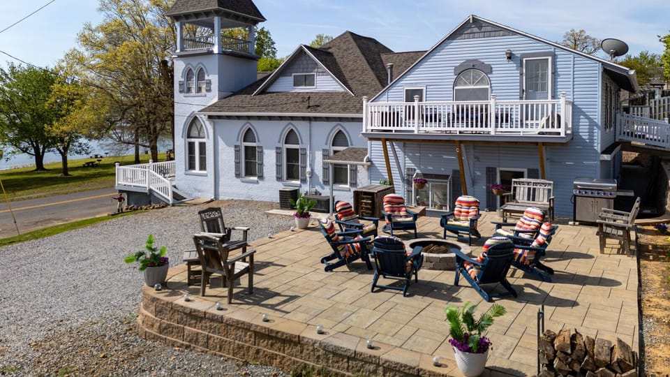 Side view of the home including the large driveway, BBQ, fire pit and relaxing yard.