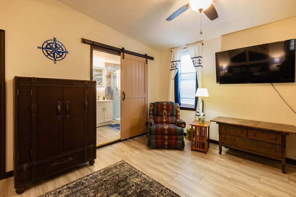 Spacious master bedroom with Smart TV and extra seating