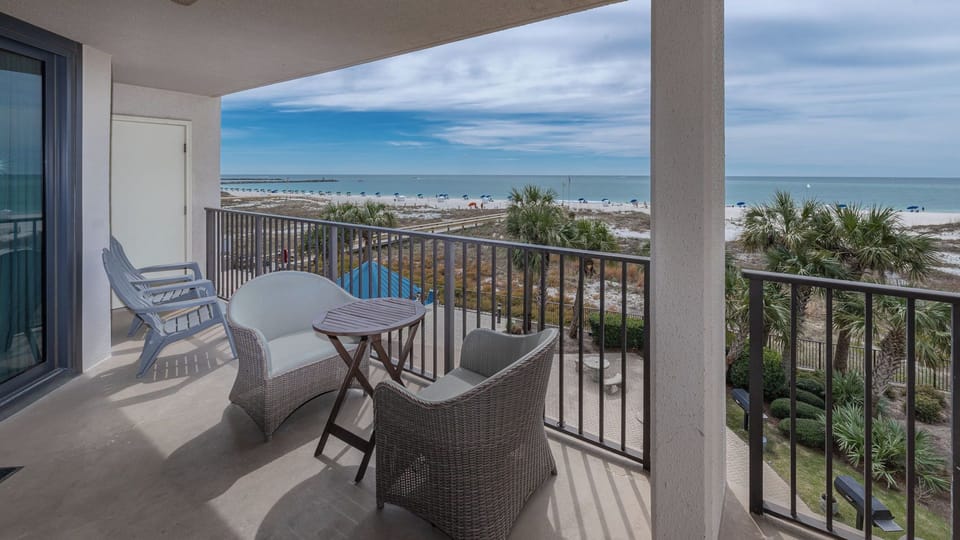 Breathe in the fresh coastal air as you relax on your balcony, taking in views of the beach and palm trees